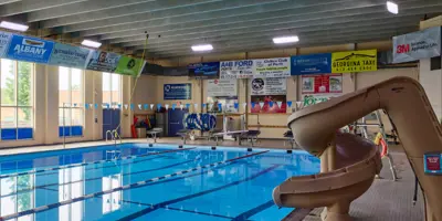 Public indoor pool with slide on right side