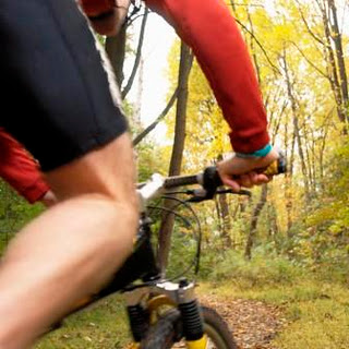 Cyclist on trail in autumn