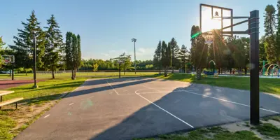 Outdoor basketball court at sunset