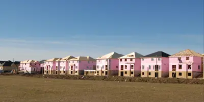 New houses being built with bare earth in the foreground