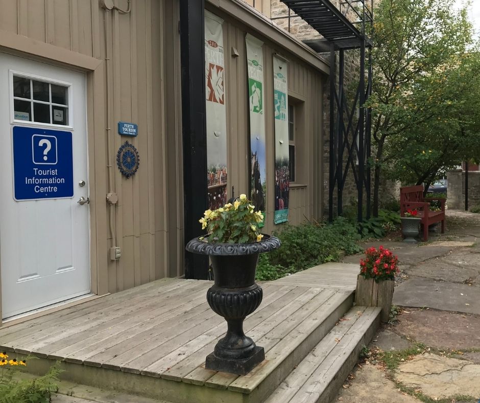 White door with blue Tourism Information Centre sign