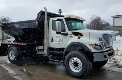 White salt truck parked with Perth logo on the door