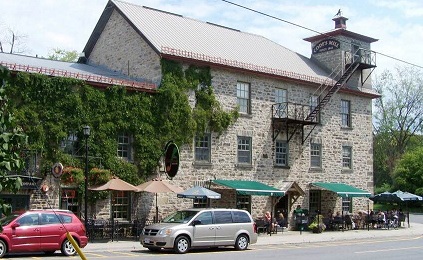 Large grey stone with restaurant patio